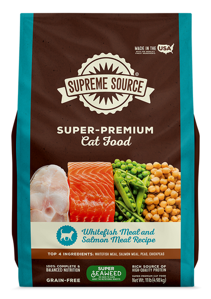 A package of Supreme Source Super-Premium Cat Food with Whitefish Meal and Salmon Meal Recipe. The bag is predominantly brown and blue with images of whitefish and salmon, and it is labeled as grain-free.