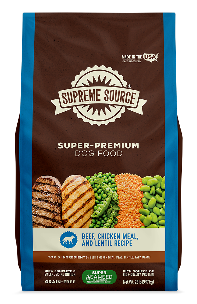 A bag of Supreme Source Premium Dry Dog Food with images of beef and chicken on the front, along with text highlighting the product as grain-free and suitable for all life stages of dogs.