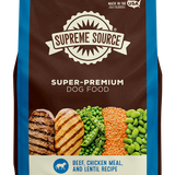 A bag of Supreme Source Premium Dry Dog Food with images of beef and chicken on the front, along with text highlighting the product as grain-free and suitable for all life stages of dogs.