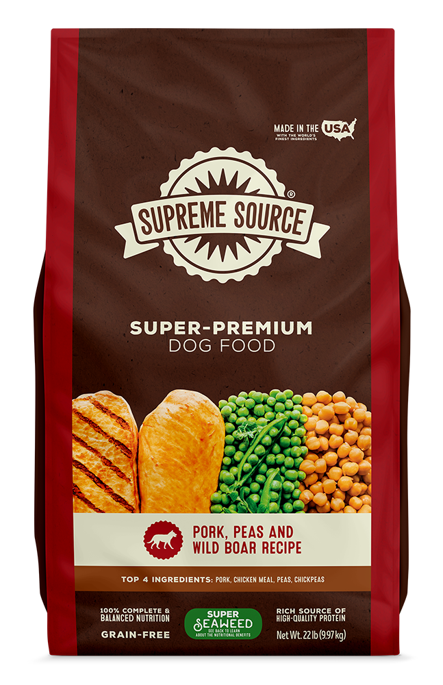 A bag of Supreme Source Premium Dry Dog Food with an image of a dog, pork, beans, and wild boar on the front.