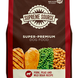 A bag of Supreme Source Premium Dry Dog Food with an image of a dog, pork, beans, and wild boar on the front.