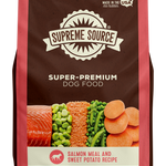 A package of Supreme Source Super-Premium Dog Food with salmon meal and sweet potato recipe. The bag is predominantly red and white, with images of salmon, sweet potatoes, and carrots on the front.