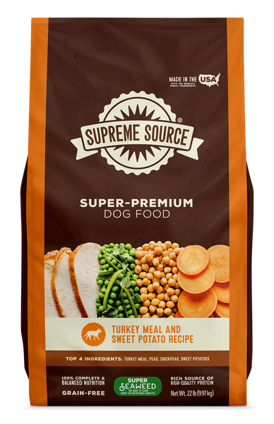 A package of Supreme Source Super-Premium Dog Food with Turkey Meal & Sweet Potato Recipe. The bag is predominantly brown with images of the product contents, which include turkey and sweet potatoes, displayed on the front.