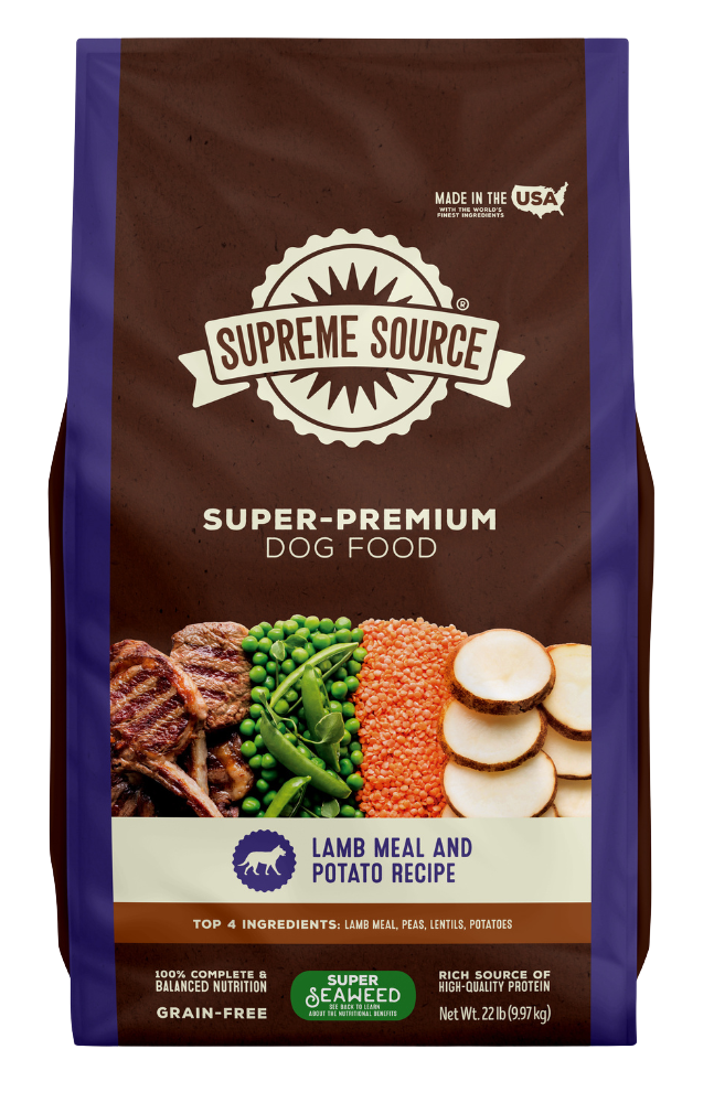 A package of Supreme Source Super-Premium Dog Food with Lamb Meal & Potato Recipe. The bag is predominantly brown and white with images of the product ingredients such as lamb, potatoes, and carrots on the front.