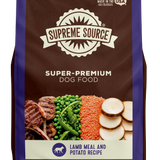 A package of Supreme Source Super-Premium Dog Food with Lamb Meal & Potato Recipe. The bag is predominantly brown and white with images of the product ingredients such as lamb, potatoes, and carrots on the front.